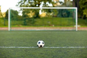 soccer ball and goal on football field